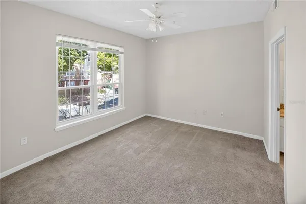 an empty room with windows and outdoor view