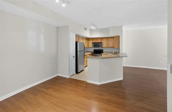 a kitchen with a refrigerator and a stove top oven