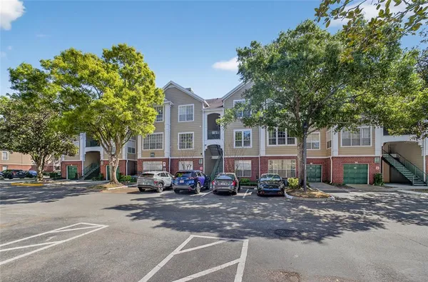 a front view of a house with a yard garage and outdoor seating