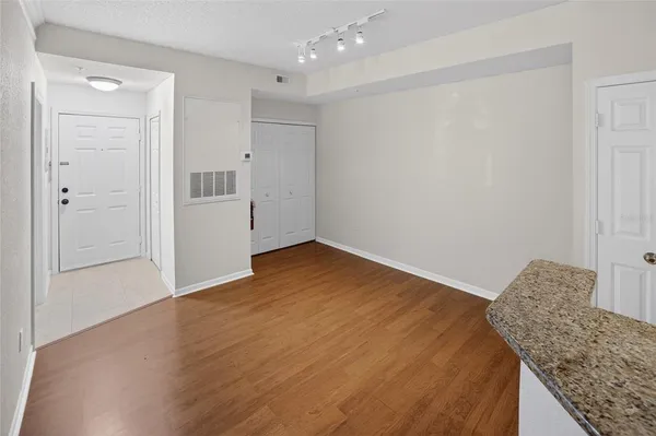 a view of livingroom with hardwood floor and kitchen view