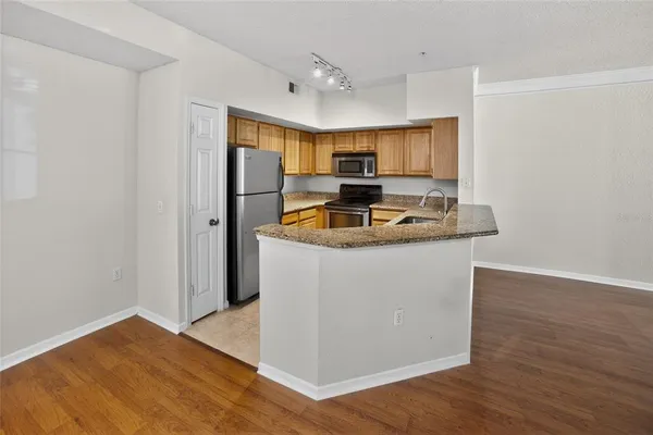 a kitchen with kitchen island a sink and a refrigerator