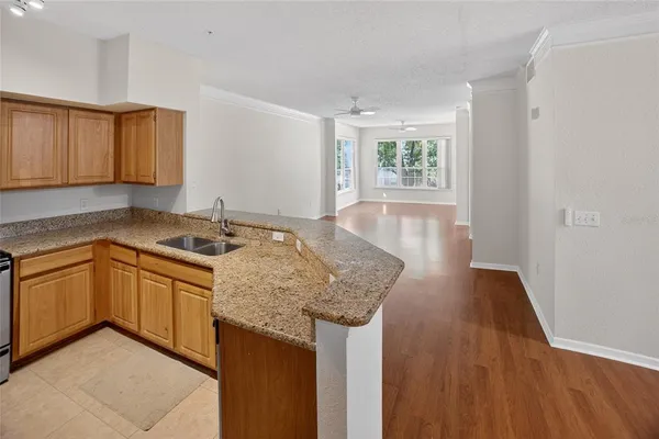 a kitchen with granite countertop sink and cabinets