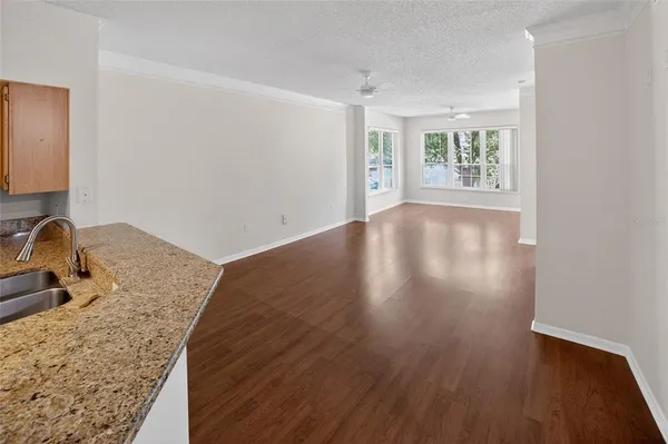 a view of a kitchen with wooden floor and a sink
