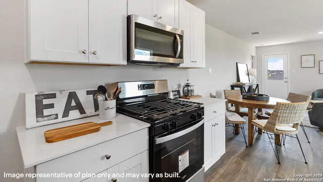 a kitchen with stainless steel appliances granite countertop a stove and a microwave