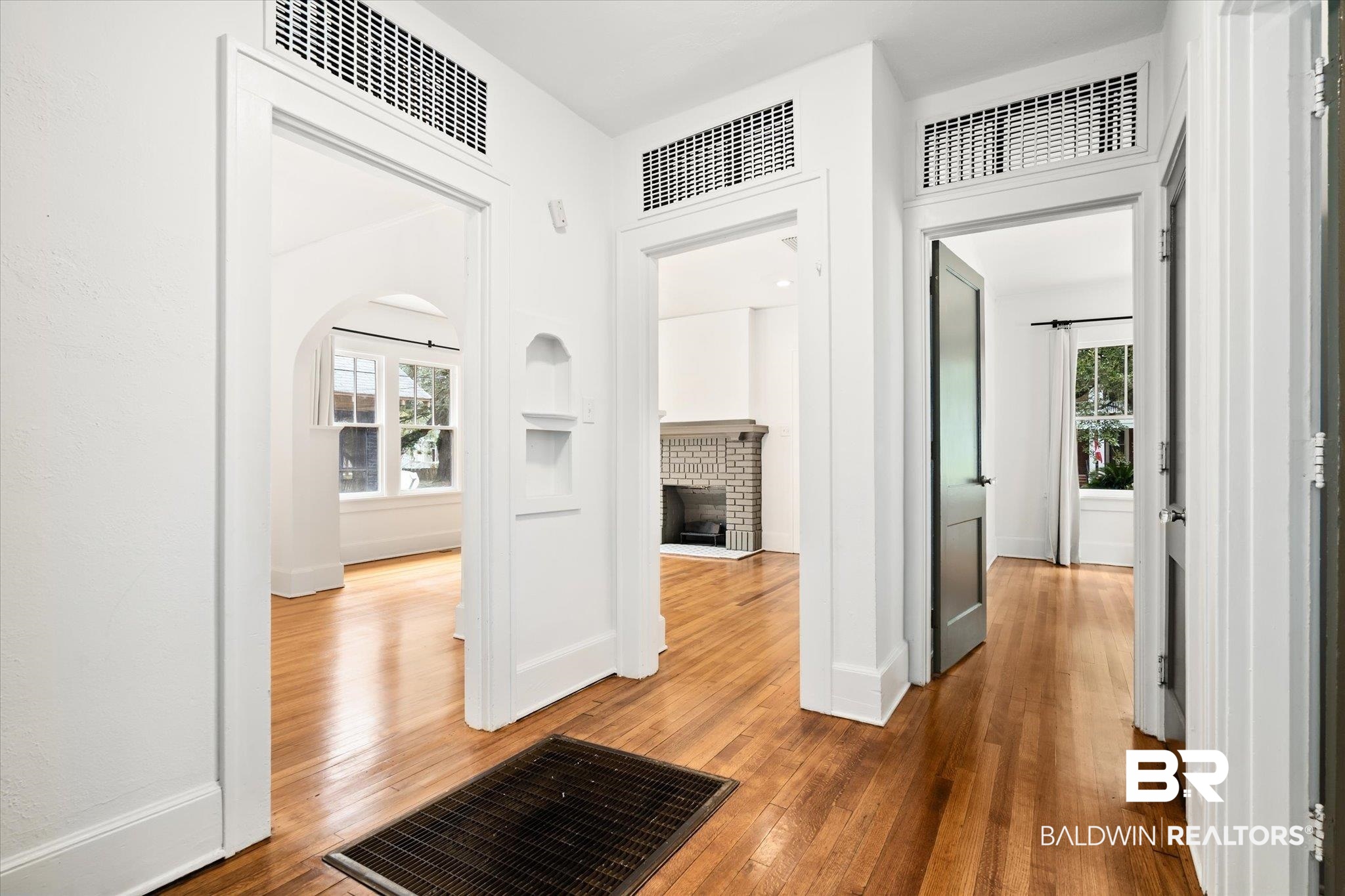 308 South Ann Street Mobile, AL 36604 - Photo 13 of 30 Hallway with plenty of natural light and hardwood / wood-style floors