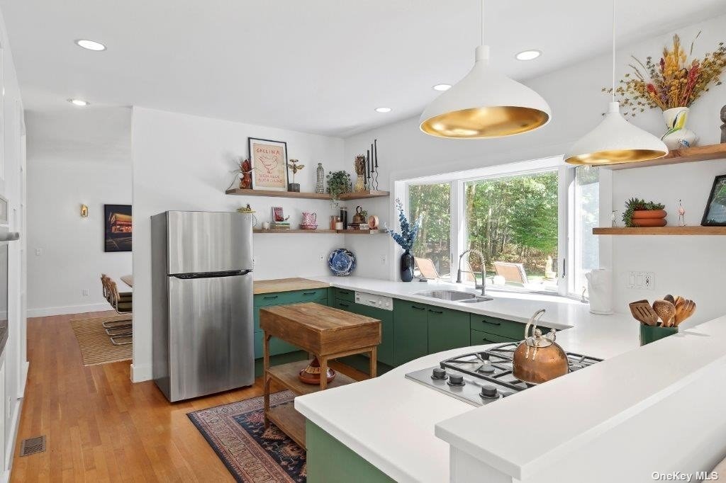 4 East Hampton, undefined 00000 - Photo 12 of 20 a kitchen with stainless steel appliances granite countertop a refrigerator sink stove and microwave