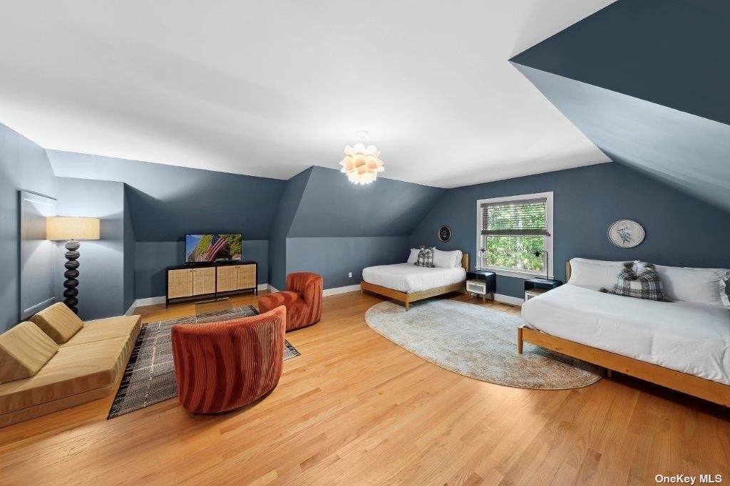 4 East Hampton, undefined 00000 - Photo 17 of 20 a bedroom with a bed and wooden floor