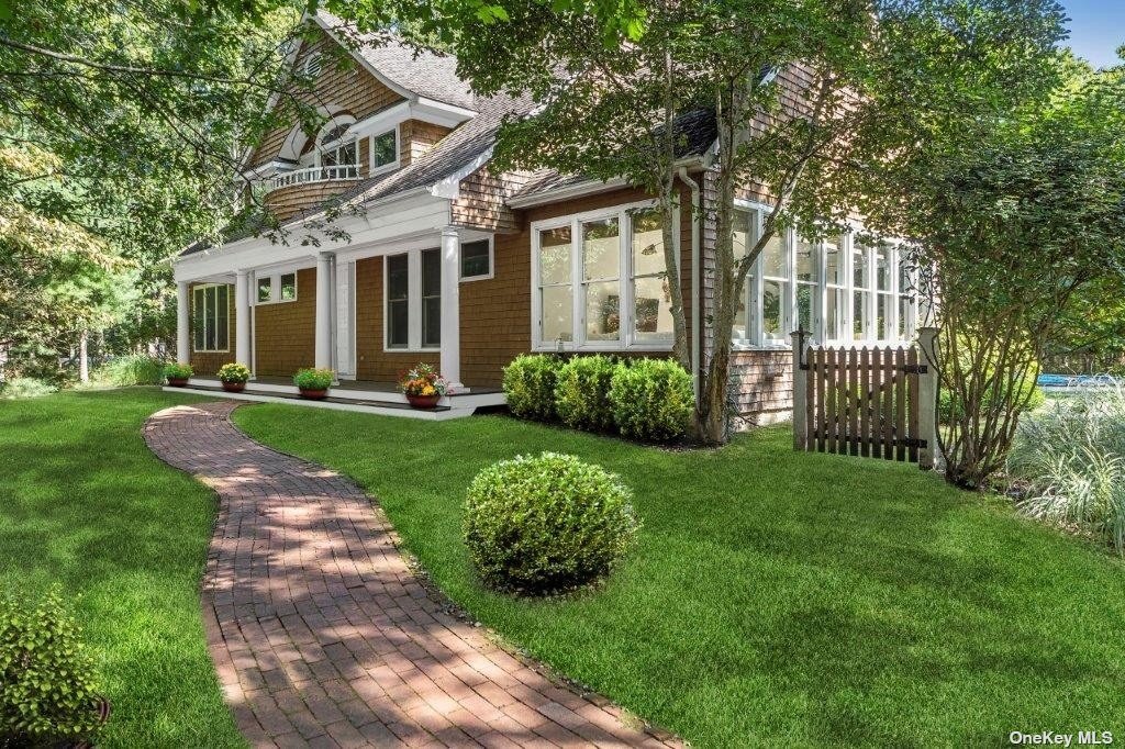 4 East Hampton, undefined 00000 - Photo 2 of 20 a front view of a house with a yard table and chairs