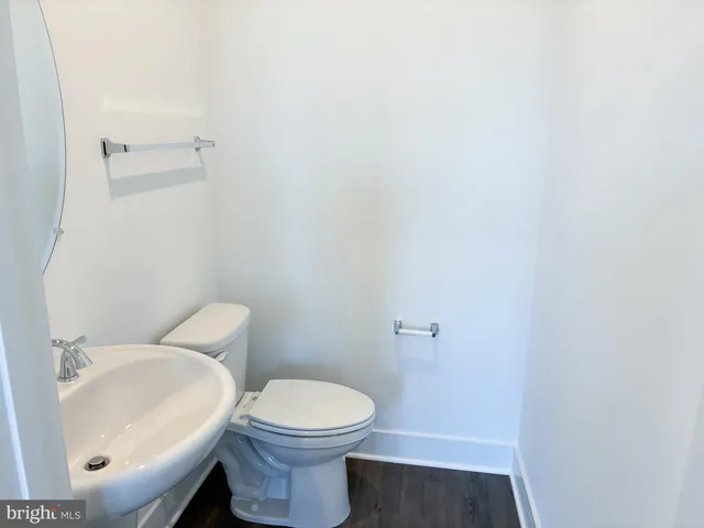 a white toilet sitting next to a white sink