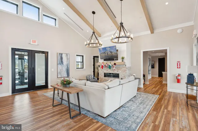 a kitchen with stainless steel appliances a dining table chairs and wooden floor