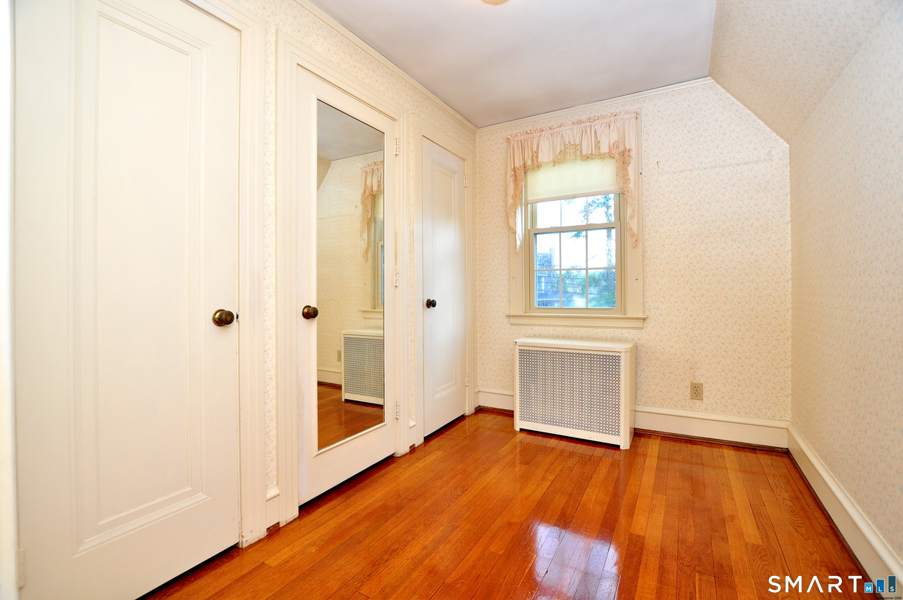 10 Harvey Road Windsor, CT 06095 - Photo 22 of 36 a view of an empty room with wooden floor and a window