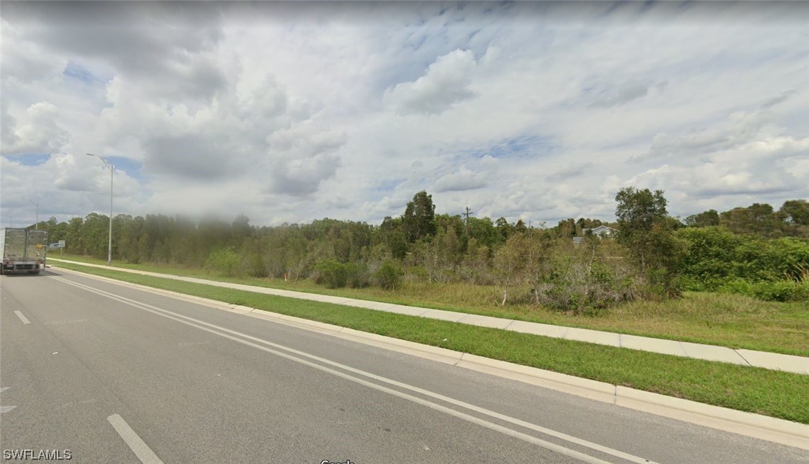 2664 Meadow Road Lehigh Acres, FL 33974 - Photo 3 of 4 a view of a yard and ocean view