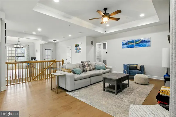 a living room with furniture ceiling fan and a rug