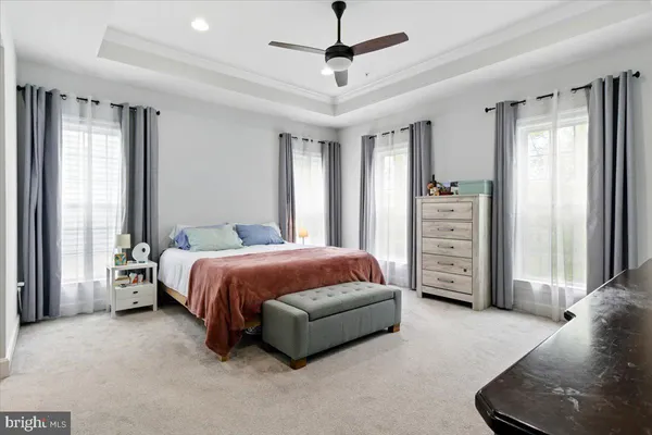 a spacious bedroom with a bed and a chandelier