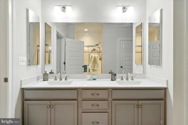 a bathroom with a double vanity sink mirror and double