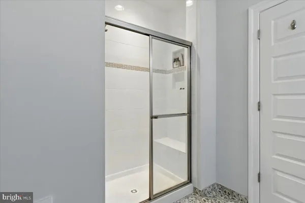 a bathroom with a glass shower door