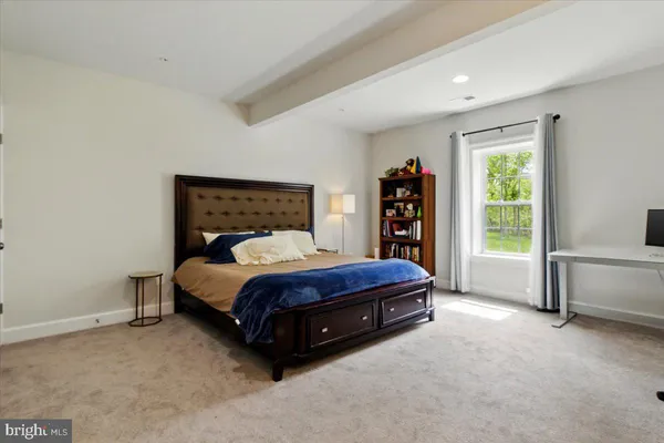 a spacious bedroom with a bed and a large window