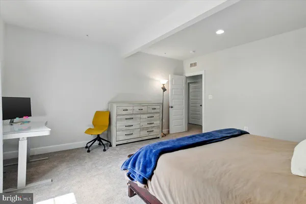 a bedroom with a bed a desk and chair