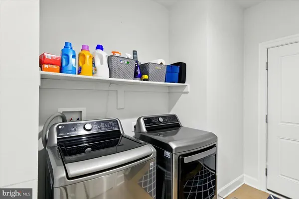 a view of storage and utility room with washer and dryer