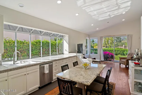 a large dining space with furniture window and wooden floor
