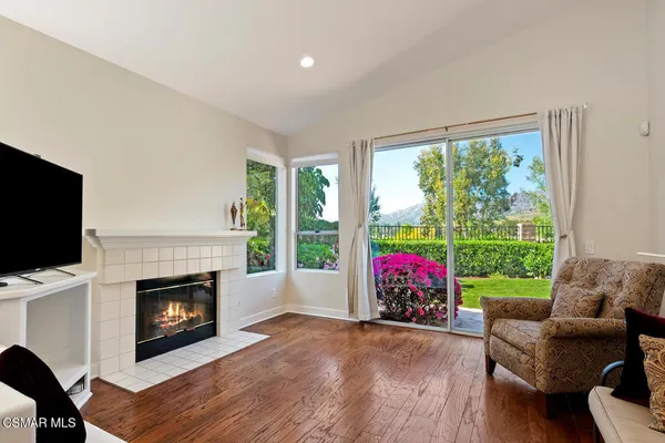 a living room with furniture fireplace and flat screen tv