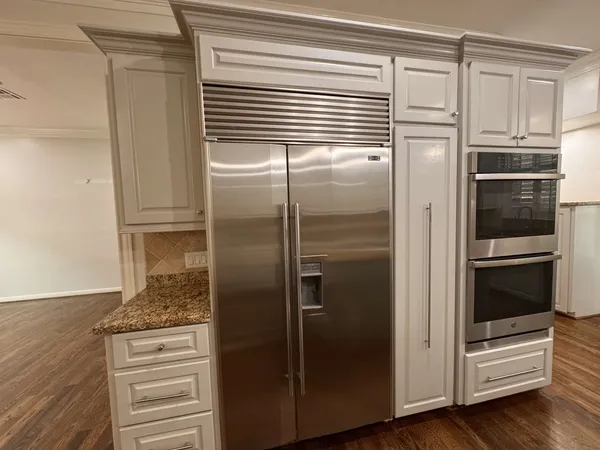a view of empty room with wooden floor and fireplace