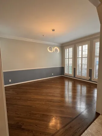 a view of room with window and wooden floor