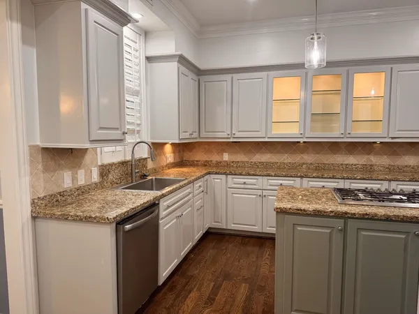 a kitchen with stainless steel appliances granite countertop a sink stove and cabinets