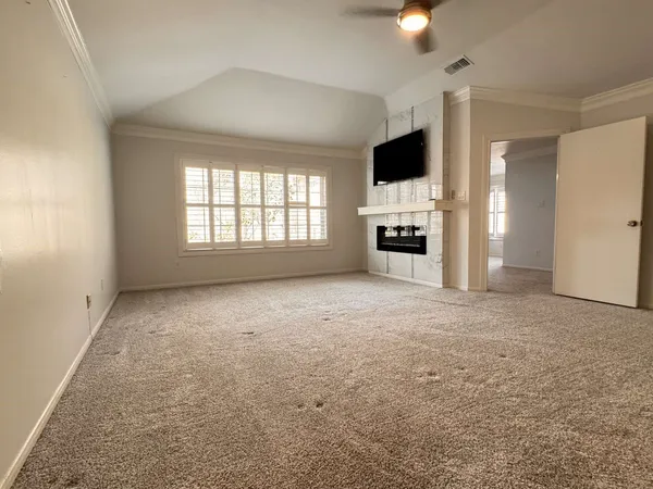 an empty room with entrance and windows