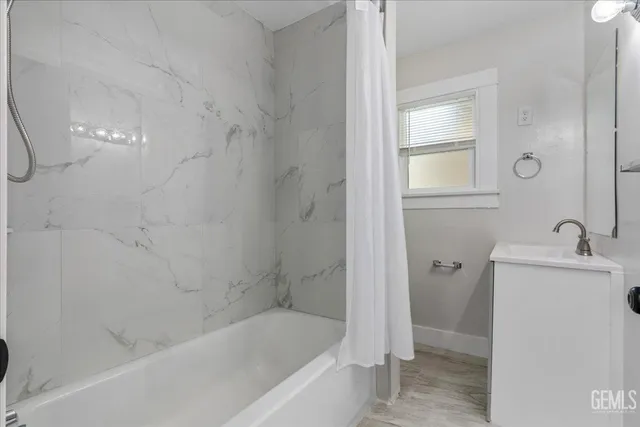 a bath room with a bath tub and a shower