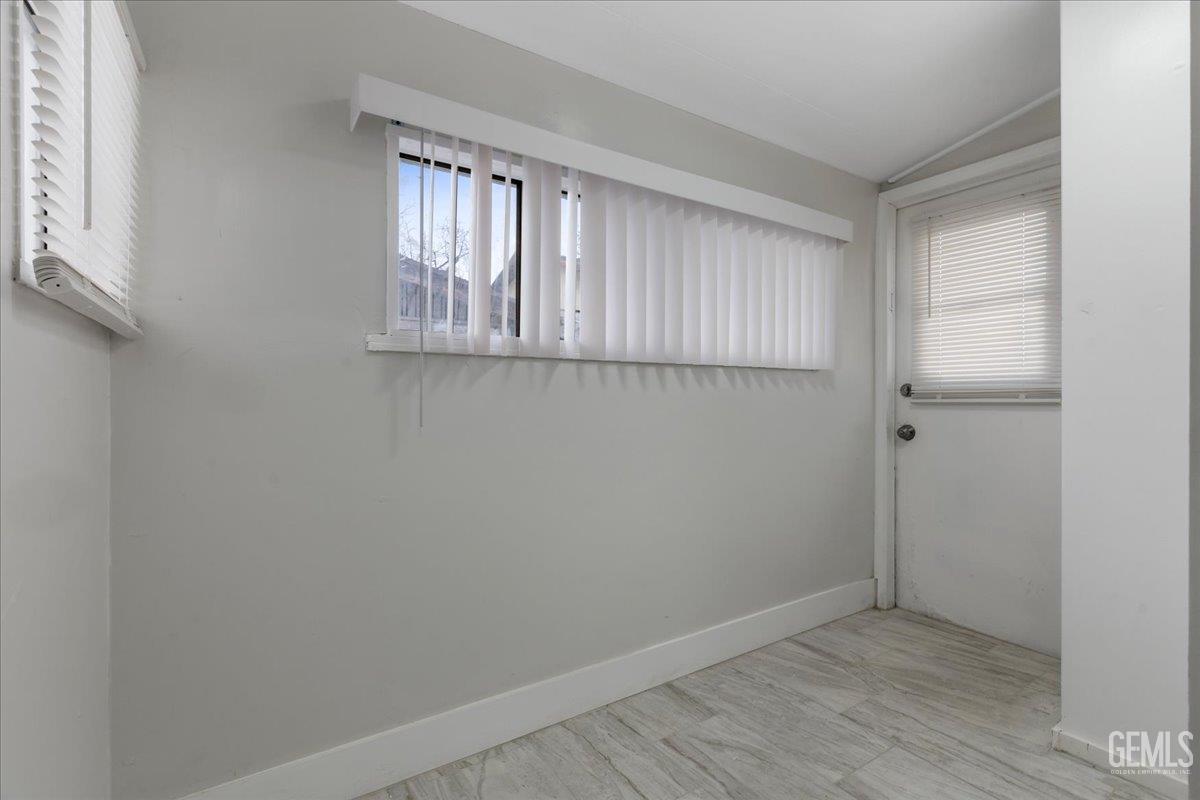 Undisclosed Address Bakersfield, CA 93304 - Photo 15 of 21 a view of an empty room with wooden floor and a window