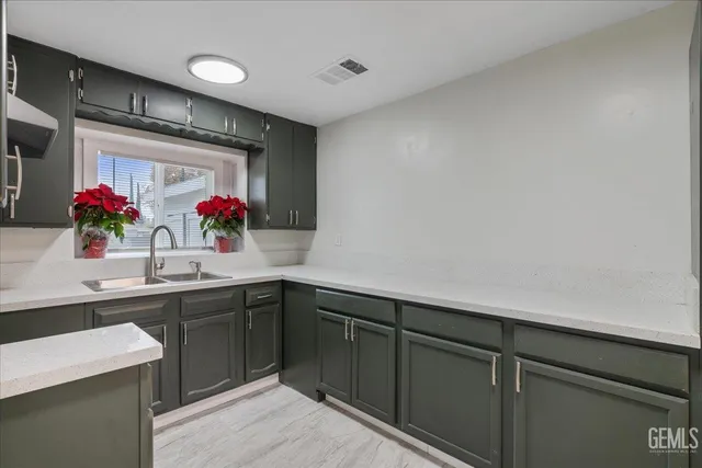 a kitchen with sink cabinets and window
