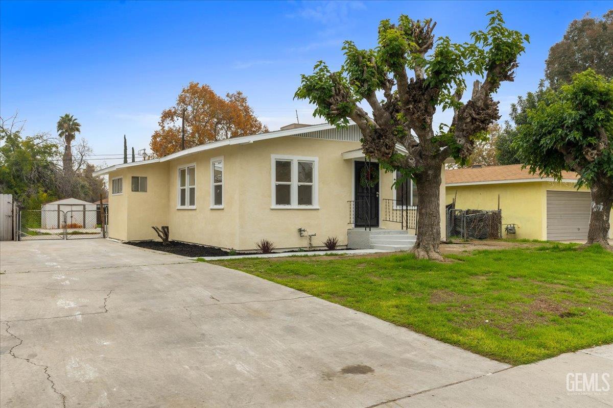 Undisclosed Address Bakersfield, CA 93304 - Photo 18 of 21 a front view of a house with a garden
