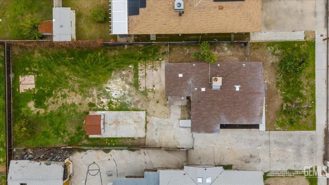 an aerial view of residential houses with outdoor space and swimming pool
