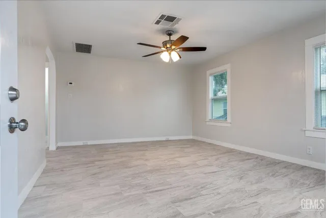 wooden floor in an empty room with a window