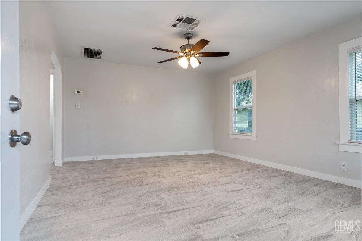 Undisclosed Address Bakersfield, CA 93304 - Photo 2 of 21 wooden floor in an empty room with a window