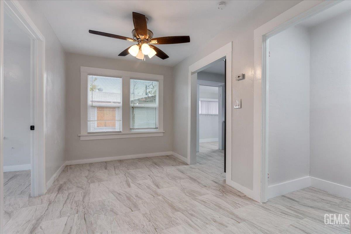 Undisclosed Address Bakersfield, CA 93304 - Photo 6 of 21 a view of an empty room with wooden floor and a window
