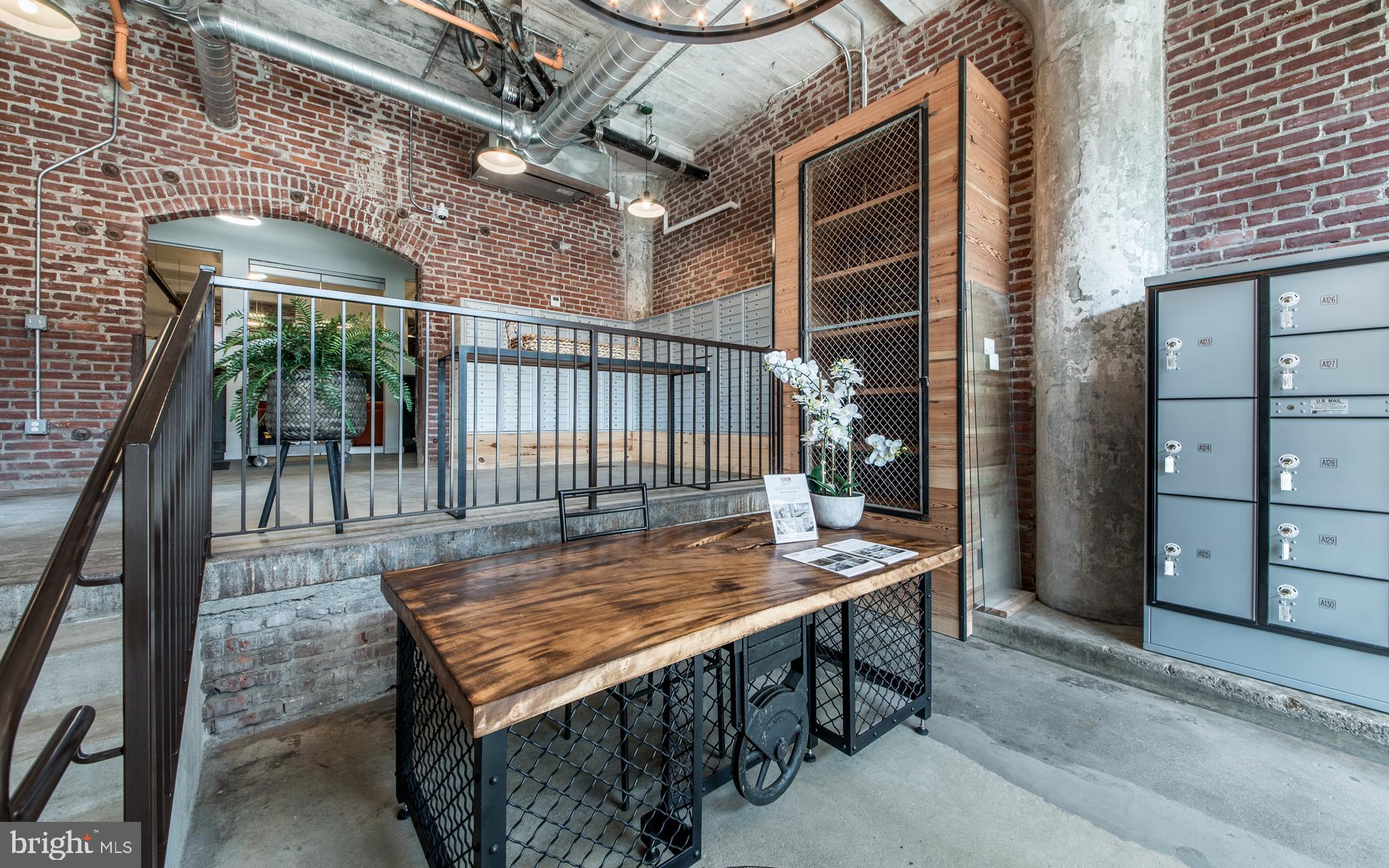 1201 Jackson Street, Unit 428 Philadelphia, PA 19148 - Photo 21 of 46 a view of a patio with table and chairs with wooden floor and fence