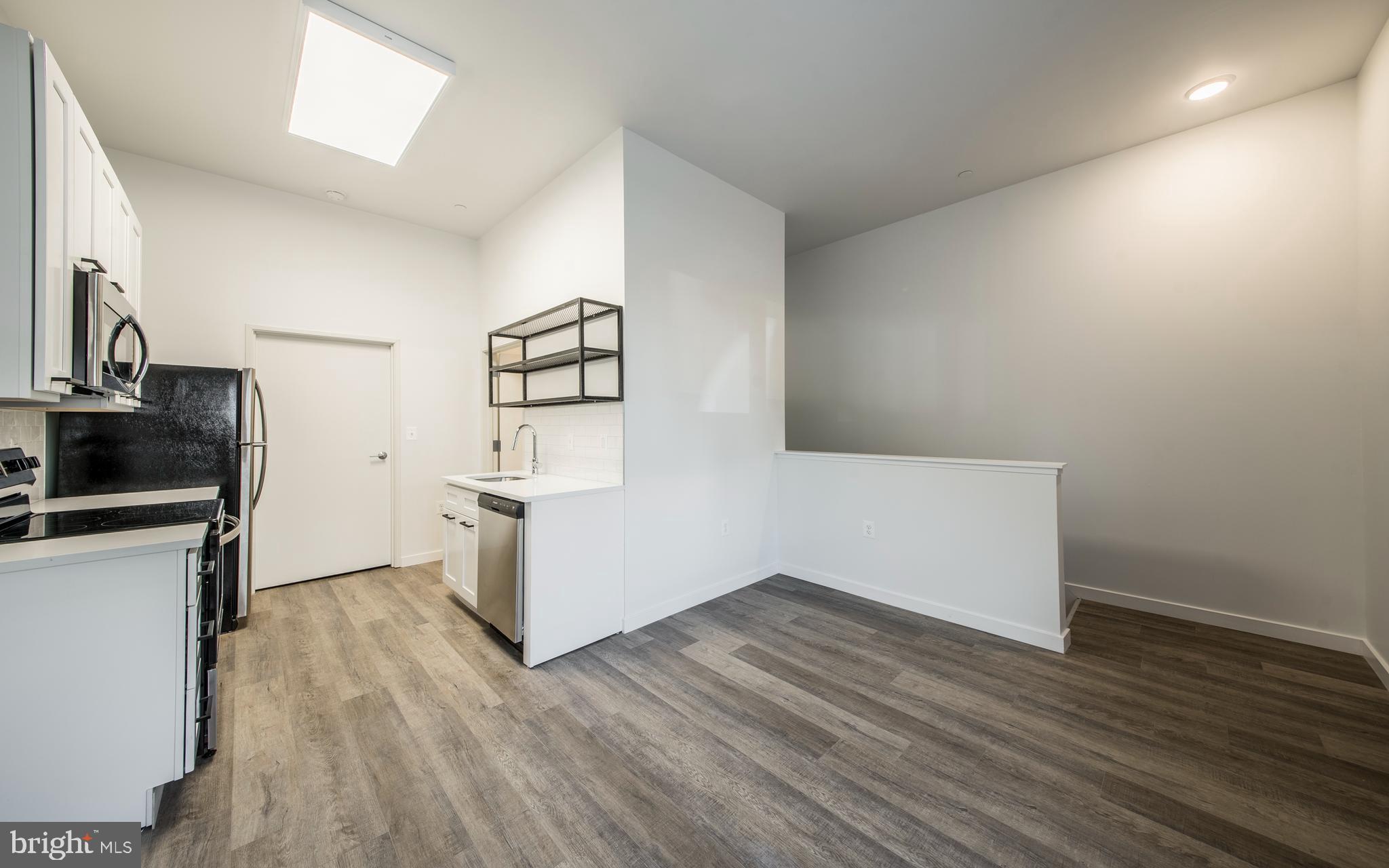 1201 Jackson Street, Unit 428 Philadelphia, PA 19148 - Photo 40 of 46 a view of a kitchen with furniture and wooden floor