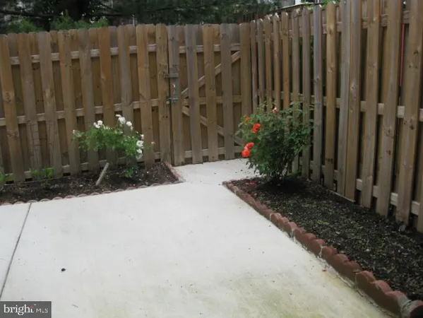 a view of garden with wooden fence
