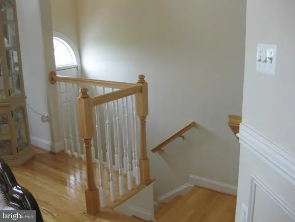a view of staircase with white walls and a window