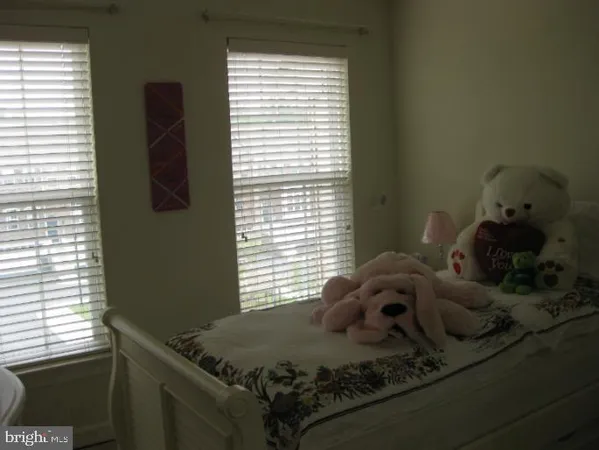 a bed sitting in a bedroom next to a window