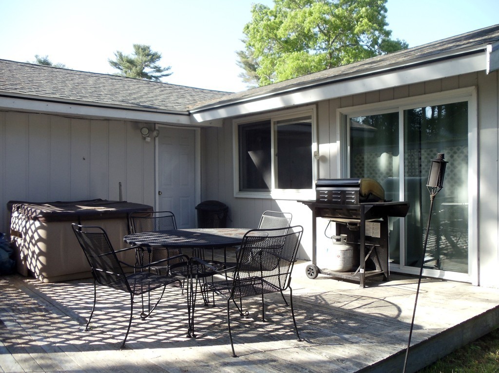 14 Naushon Road Wareham, MA 02576 - Photo 17 of 17 a backyard of a house with table and chairs