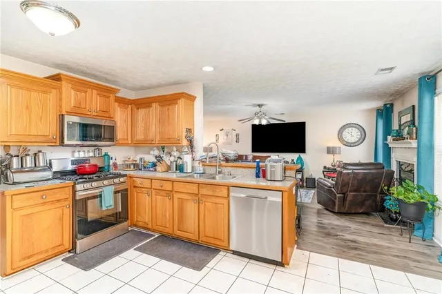 a kitchen with stainless steel appliances kitchen island granite countertop a sink and cabinets