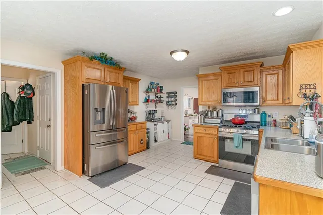 a kitchen with refrigerator and cabinets