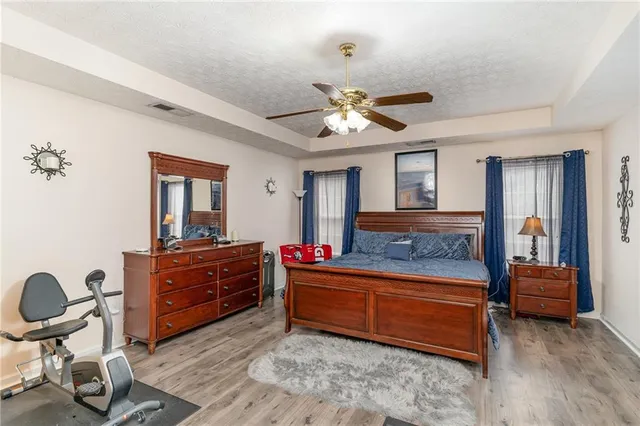 a room with a bed and a chandelier