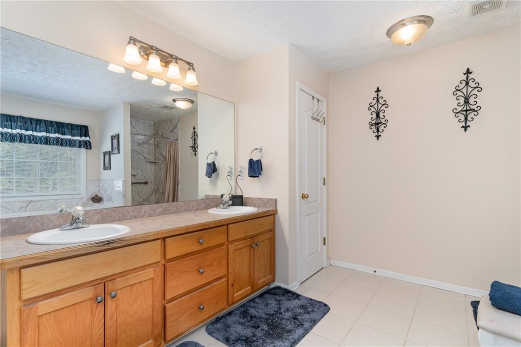 40 Cindy Circle Covington, GA 30016 - Photo 22 of 34 a bathroom with a double vanity sink and a mirror