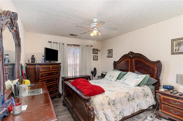 a bedroom with a bed and a tv