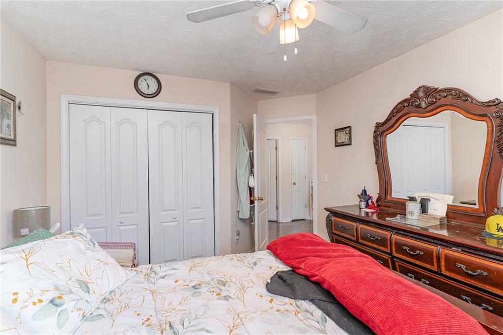 40 Cindy Circle Covington, GA 30016 - Photo 26 of 34 a bedroom with a bed and a mirror on dresser