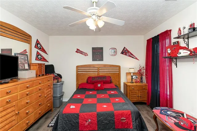 a bedroom with a bed and a dresser in it